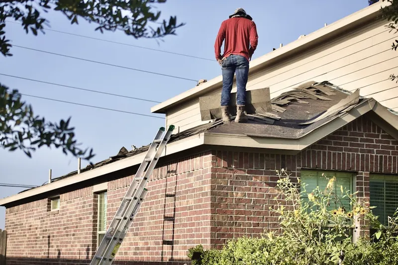 Professional roofer working on a residential roof in Packanack Lake